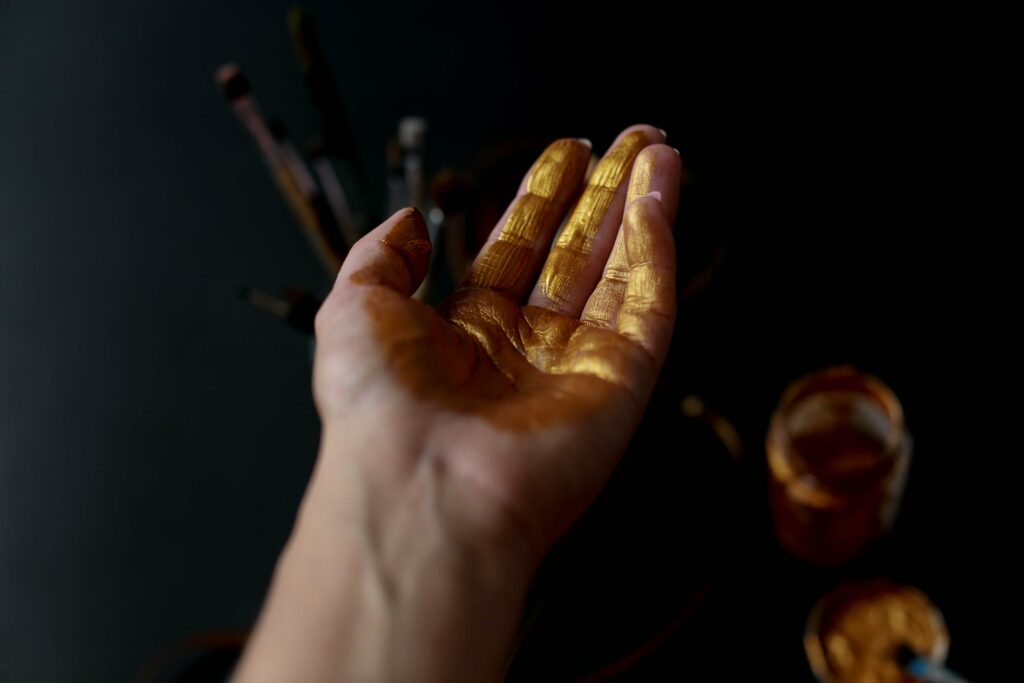 Hand covered in Gold paint