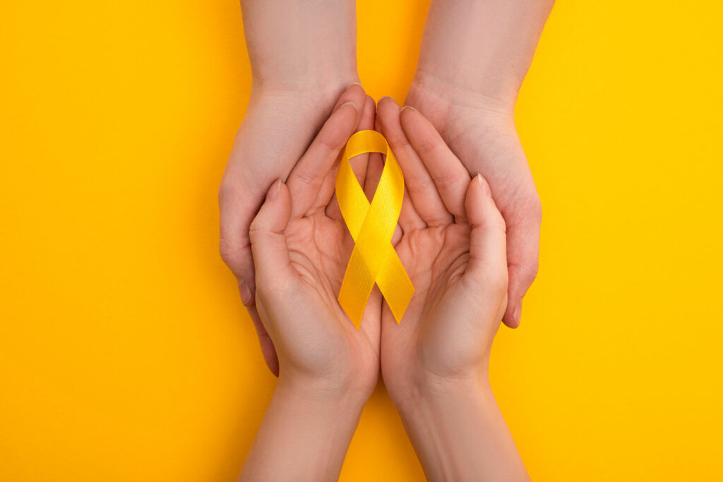 Childhood Cancer Ribbon in hands